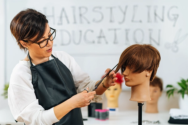 Hairstyling Education - Hairstylist Explaining Haircutting Techniques